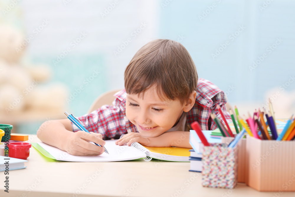 Cute little boy studying at home Cute little boy studying at home