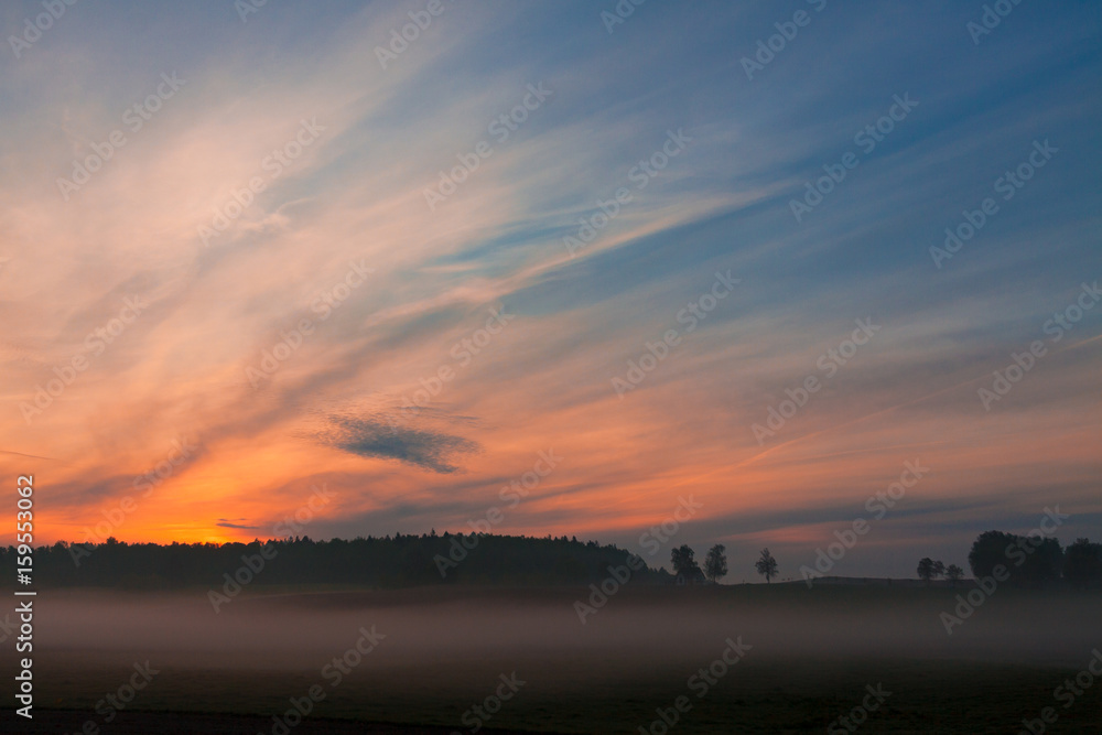 Beautiful field and road landscape with sunrise or sunset