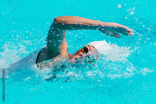 Female swimmer on training in the swimming pool © Microgen