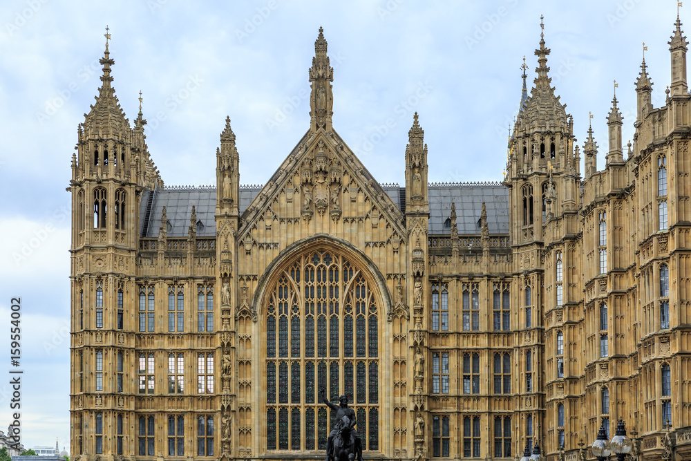 The Palace of Westminster facade with King Richard I (Houses of Parliament) statue in front, London