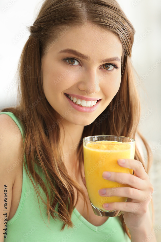 Weight loss concept. Beautiful young woman drinking healthy delicious smoothie on light background Weight loss concept. Beautiful young woman drinking healthy delicious smoothie on light background