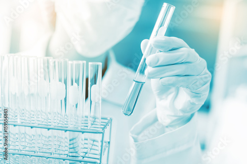 scientist hand holding laboratory test tube, science laboratory research and development concept