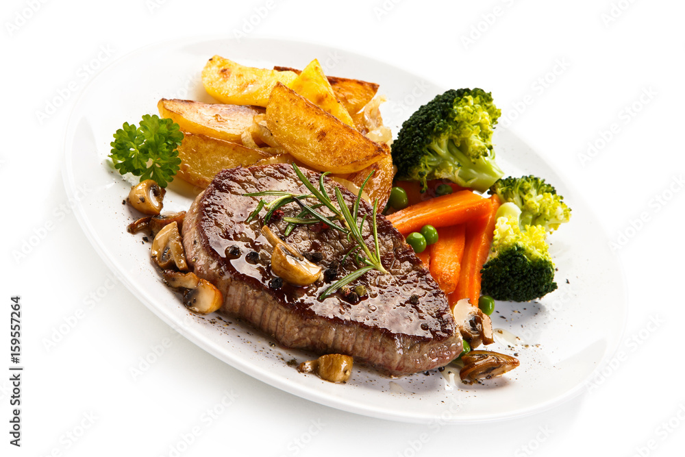 Grilled beefsteak with broccoli and carrot on white background Grilled beefsteak with broccoli and carrot on white background