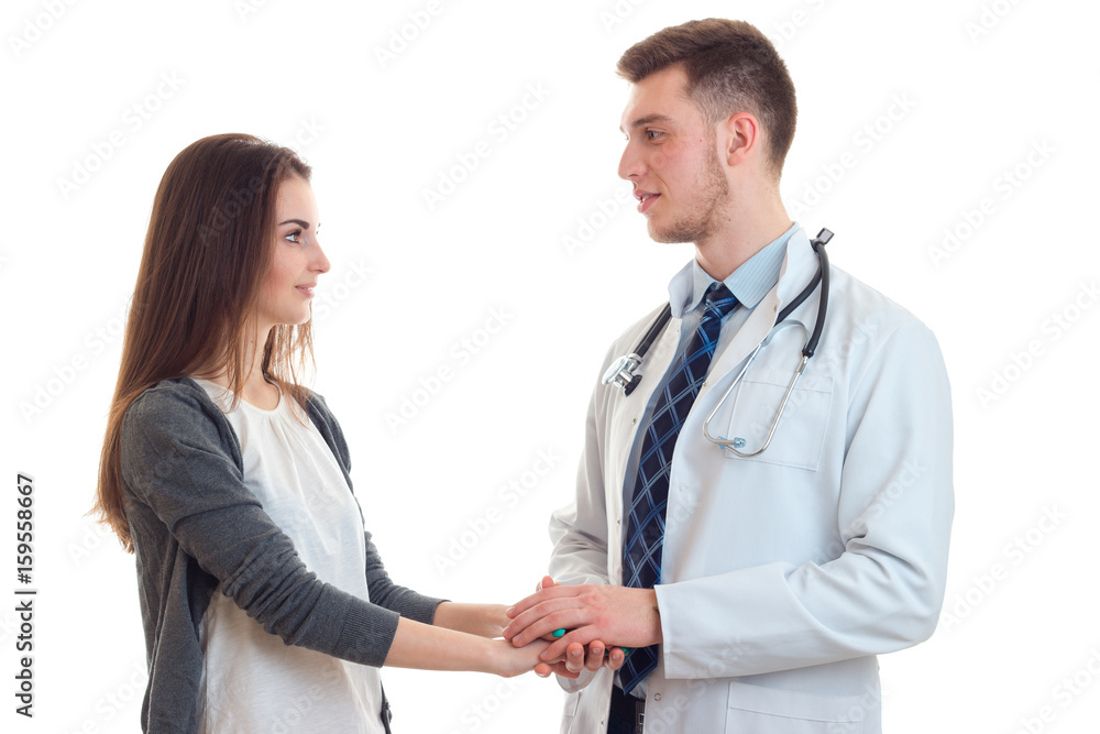 young doctor holding the hand of a patient young doctor holding the hand of a patient