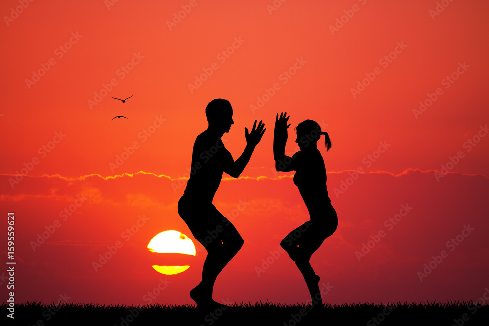 couple doing yoga at dawn