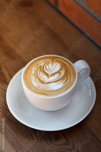 Coffee latte art in coffee shop in vintage color filter