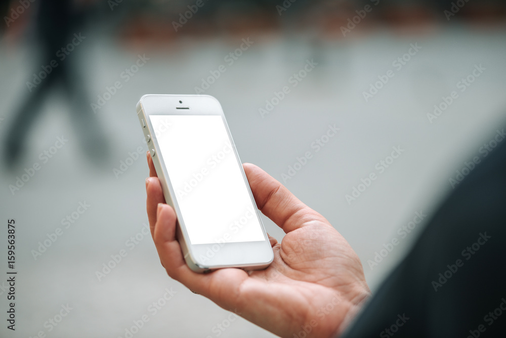 Closeup of female hands and smart phone on white screen Closeup of female hands and smart phone on white screen