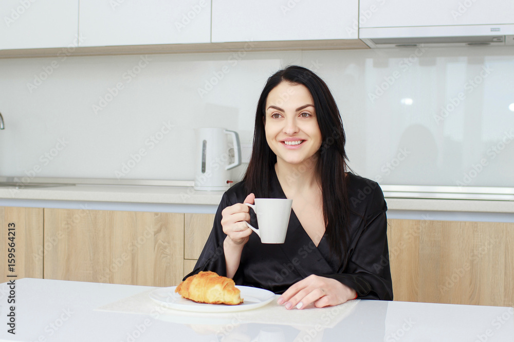 Young smiling woman having breakfast.Morning ritual