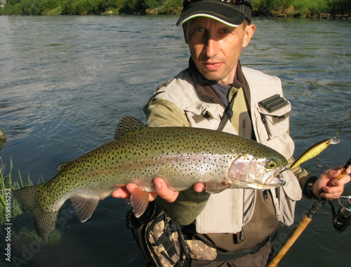 Fishing - fisherman catch rainbow trout