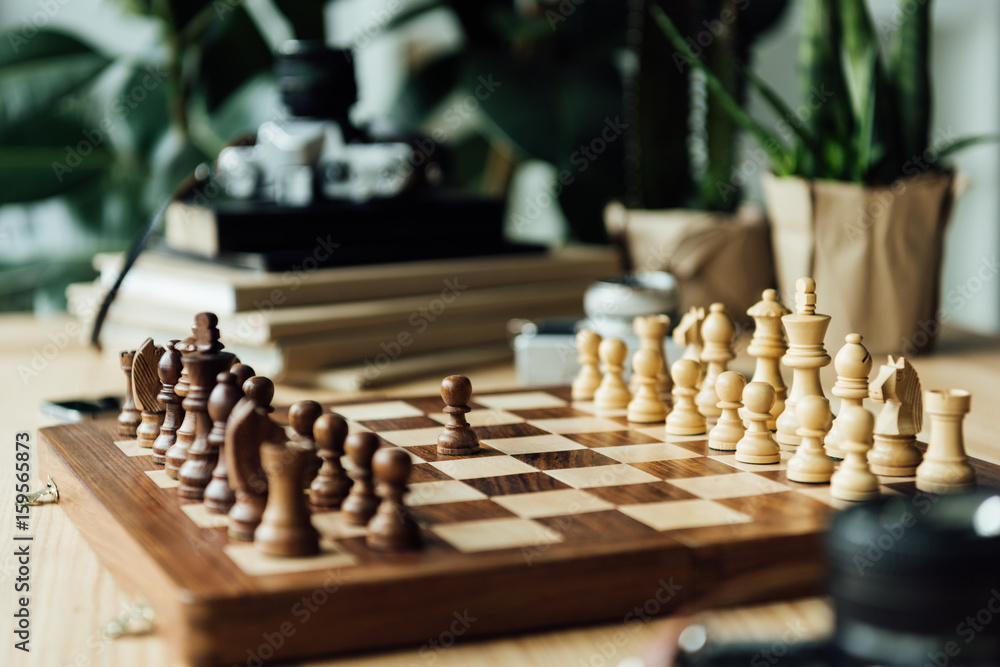 One black pawn staying against full set of chess pieces at the table One black pawn staying against full set of chess pieces at the table