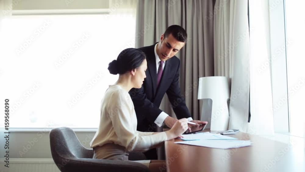 business team with papers and tablet pc at hotel business team with papers and tablet pc at hotel