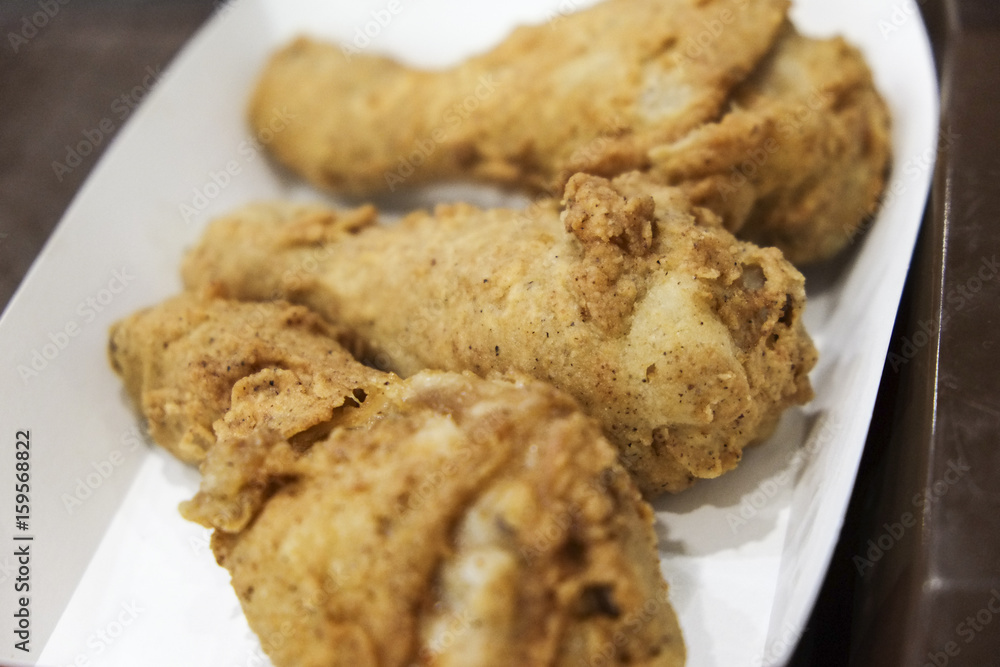 Crispy fried chicken drumsticks on paper plate Crispy fried chicken drumsticks on paper plate