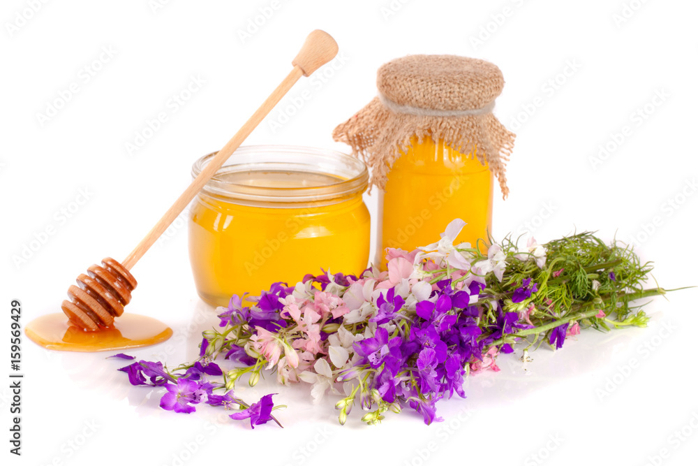 Jar of honey with wildflowers isolated on white background Jar of honey with wildflowers isolated on white background