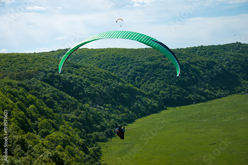 Paragliding over the river valley in summer sunny day. Dniester river, Ukraine.
