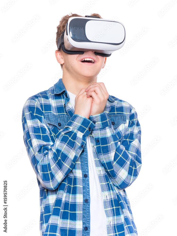 Amazed teen boy screaming, wearing virtual reality goggles watching movies or playing video games. Surprised teenager looking in VR glasses. Child experiencing 3D gadget technology. Amazed teen boy screaming, wearing virtual reality goggles watching movies or playing video games. Surprised teenager looking in VR glasses. Child experiencing 3D gadget technology.