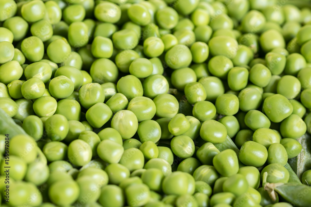 Closeup macro pile of fresh green peas ready for cleaning Closeup macro pile of fresh green peas ready for cleaning