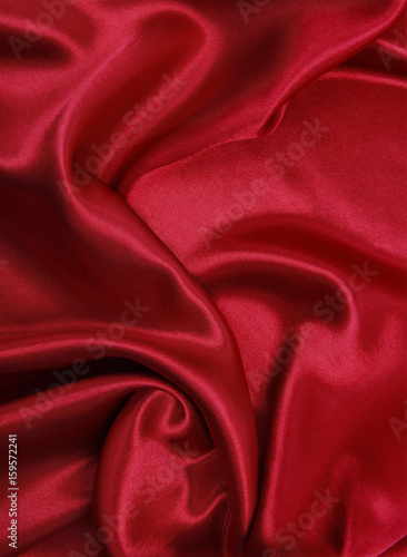 Smooth elegant red silk or satin luxury cloth texture as abstract background. Luxurious background design