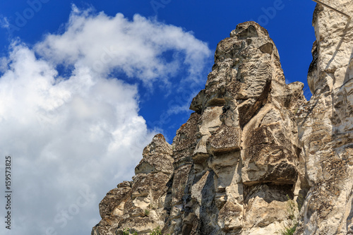 Chalk cliffs or rocks, mountain peak at background blue sky