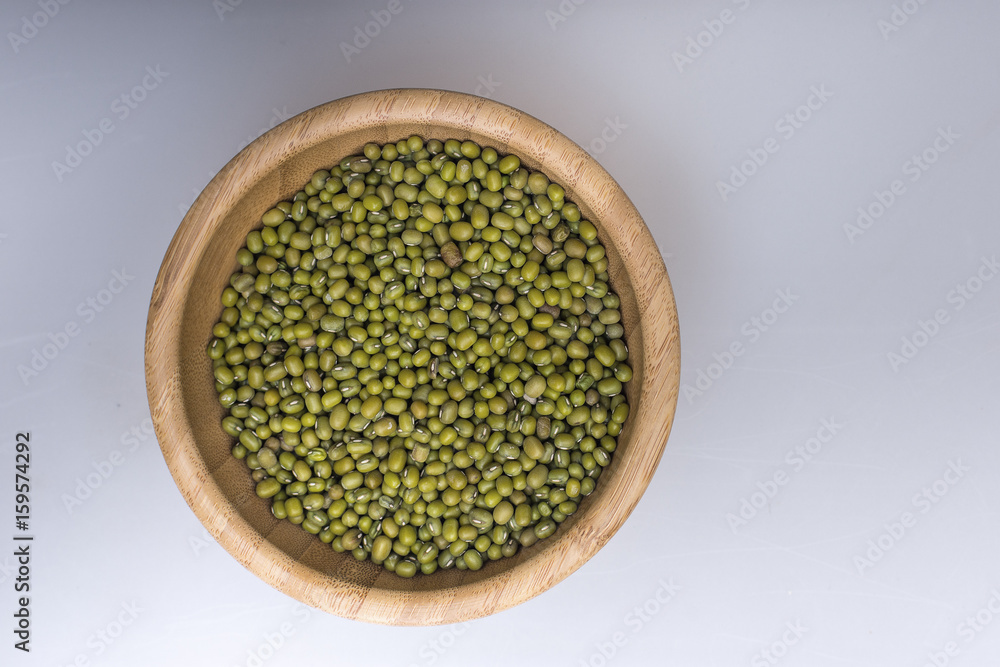 Mung bean in a wooden bowl on white background Mung bean in a wooden bowl on white background