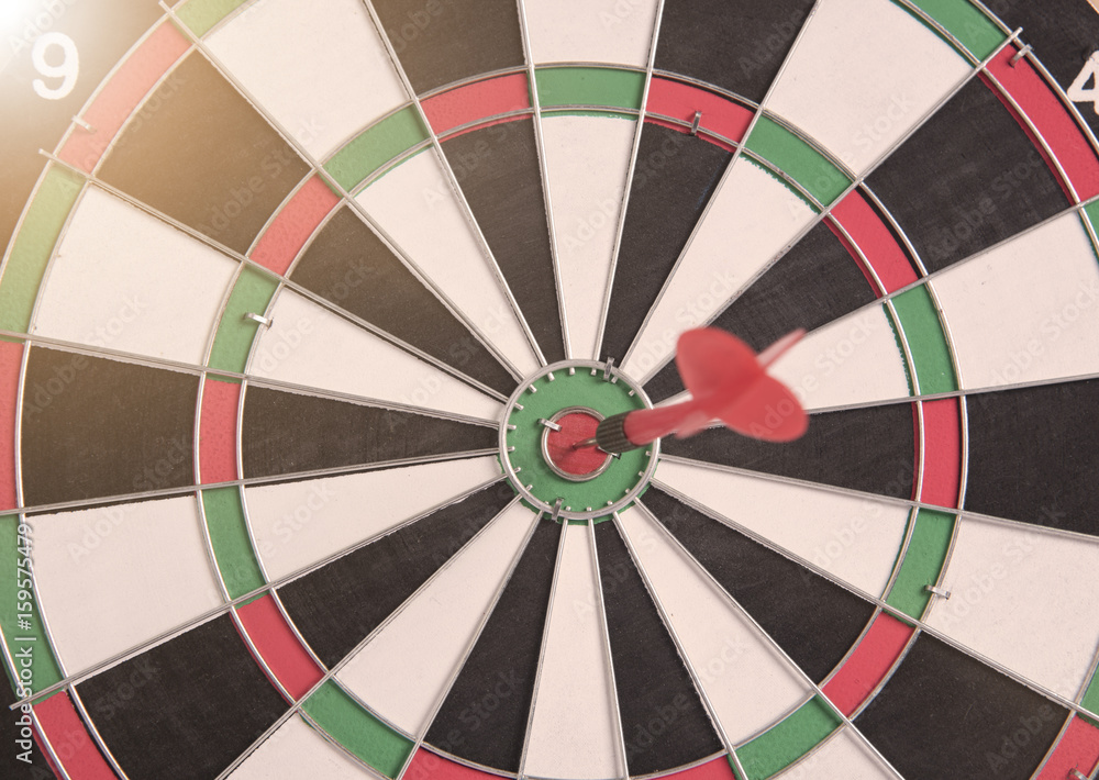 target red arrow on center of dartboard. concept business goal to marketing success. target red arrow on center of dartboard. concept business goal to marketing success.
