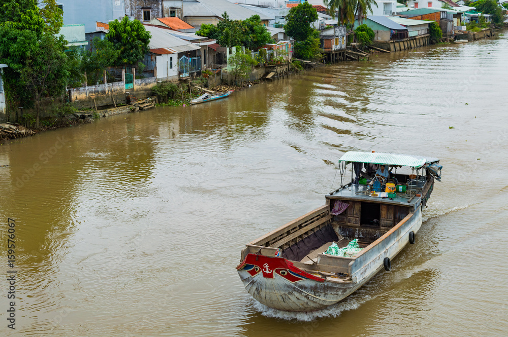 Wooden cargo boat on the Mekong River Delta