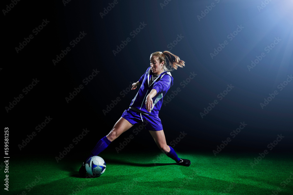 Young female soccer player dribbling ball Young female soccer player dribbling ball