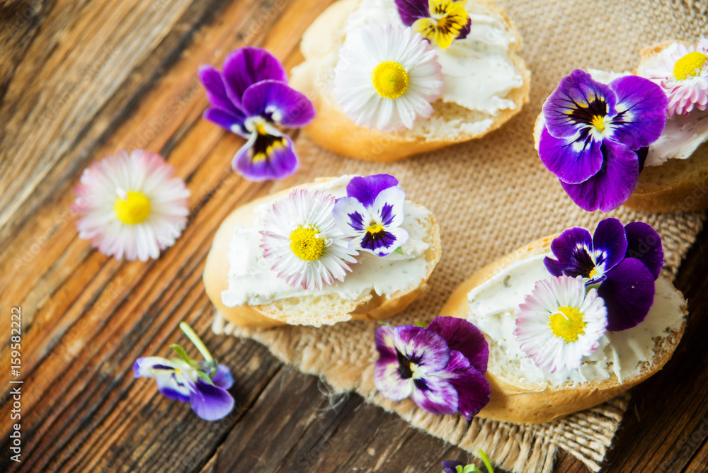Sandwich with herb and edible flowers butter on marble cutting board. Healthy food. Sandwich with herb and edible flowers butter on marble cutting board. Healthy food.