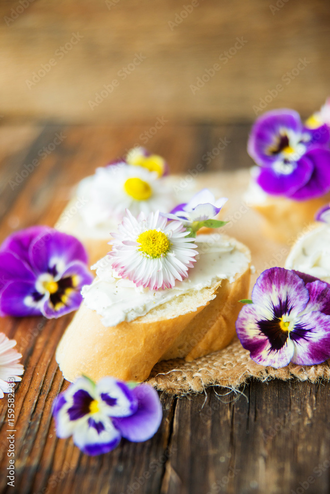 Sandwich with herb and edible flowers butter on marble cutting board. Healthy food. Sandwich with herb and edible flowers butter on marble cutting board. Healthy food.