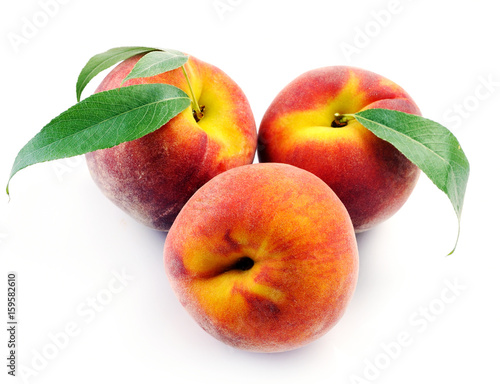 Fresh peach with green leaf isolated on white background.
