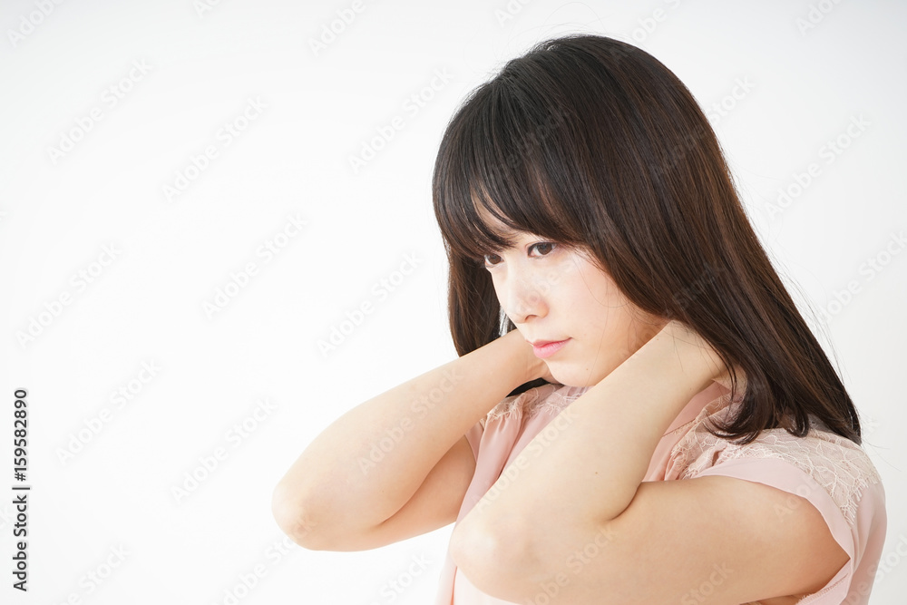 Young woman feeling stiff in her shoulders Young woman feeling stiff in her shoulders