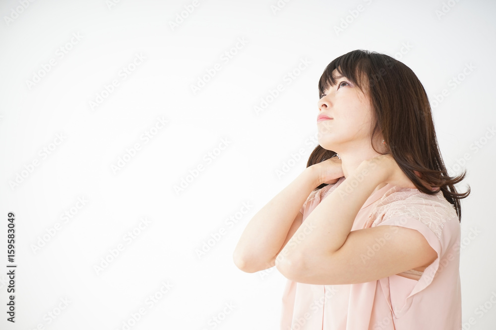 Young woman feeling stiff in her shoulders Young woman feeling stiff in her shoulders