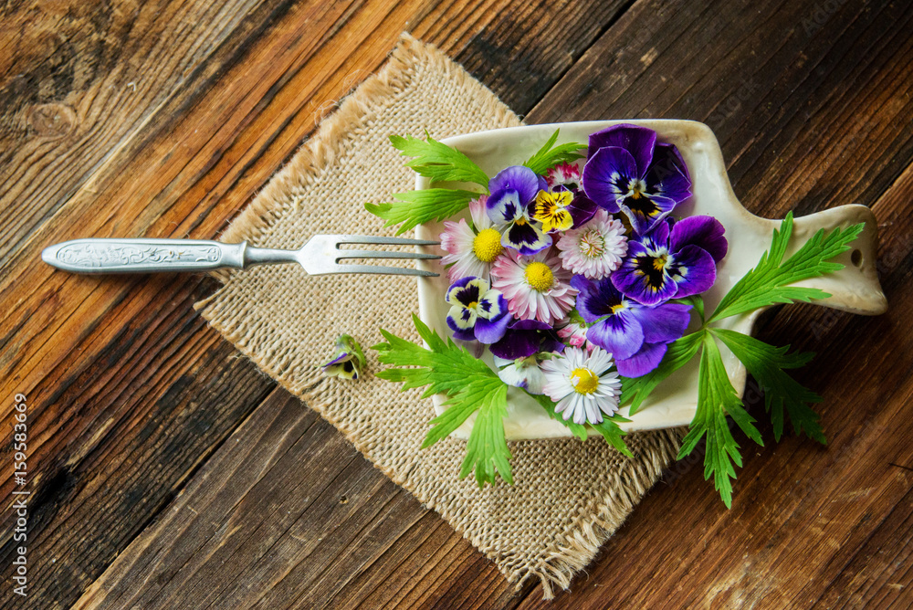 Fresh salad with smoked salmon, black olives, cherry tomatoes and edible flowers on wooden background. Fresh salad with smoked salmon, black olives, cherry tomatoes and edible flowers on wooden background.