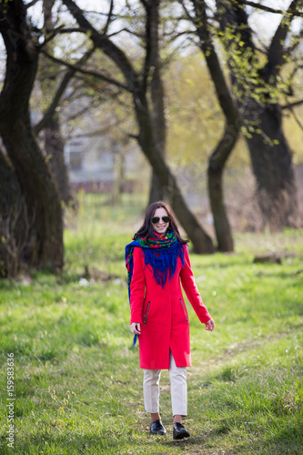 Young lady in coat and sunglasses