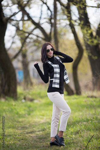 Young lady in jacket and sunglasses