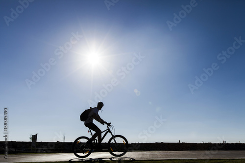 Passing Silhouette on Park Path photo