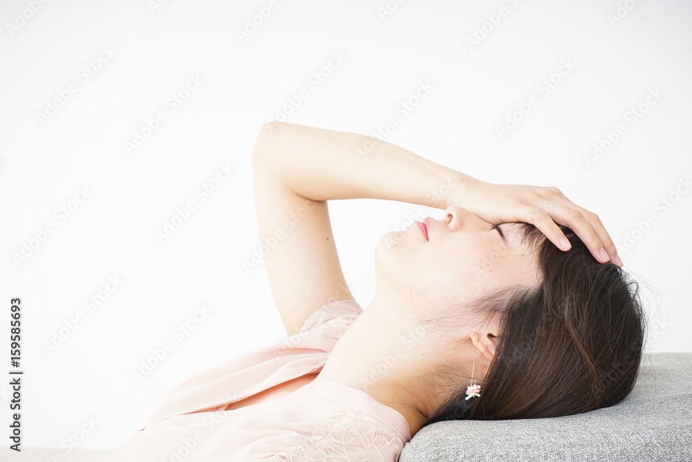 Young woman getting lying down because of poor health Young woman getting lying down because of poor health