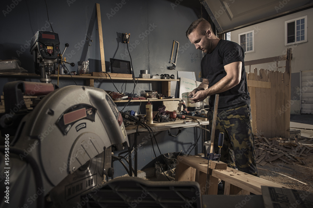 Male carpenter busy in workshop Male carpenter busy in workshop
