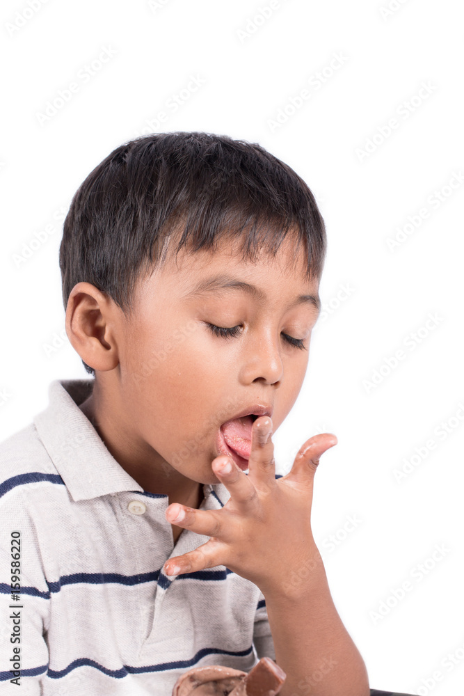cute little boy licking fingers while eating ice cream cute little boy licking fingers while eating ice cream