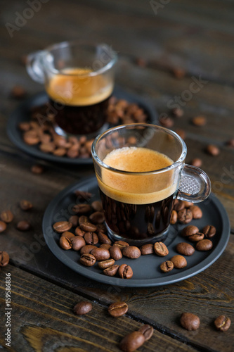 Wallpaper Mural Two cups of espresso and coffee beans on a wooden table Torontodigital.ca
