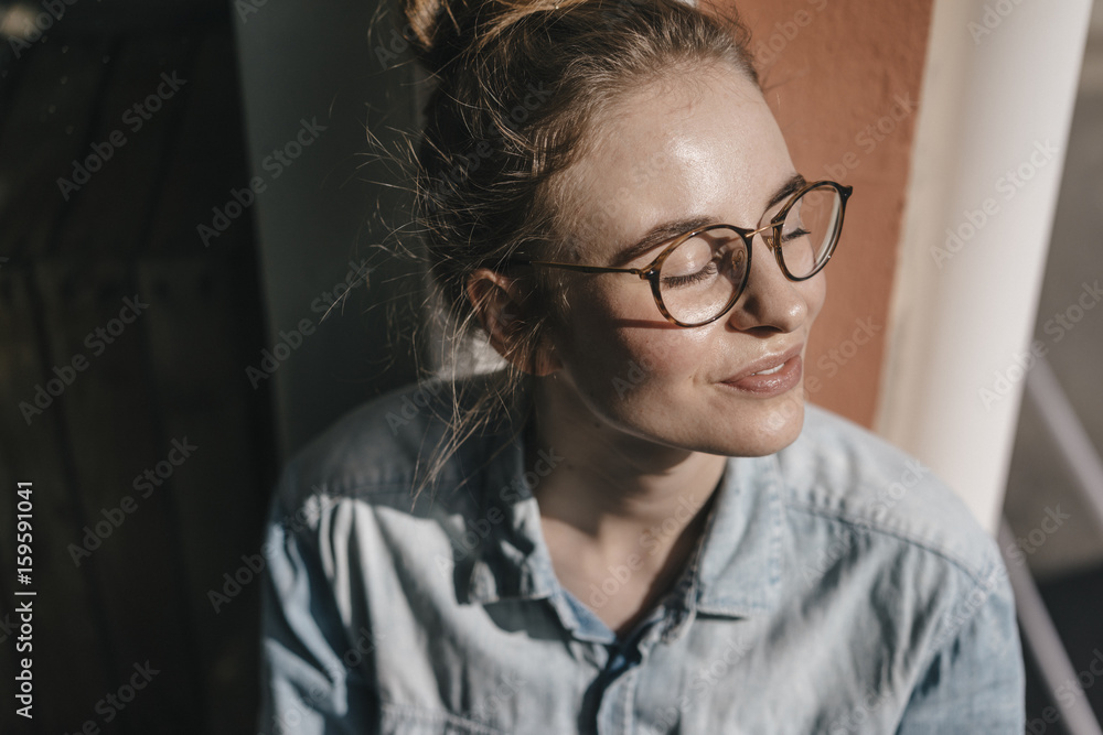 Young woman with glasses in sunlight Young woman with glasses in sunlight