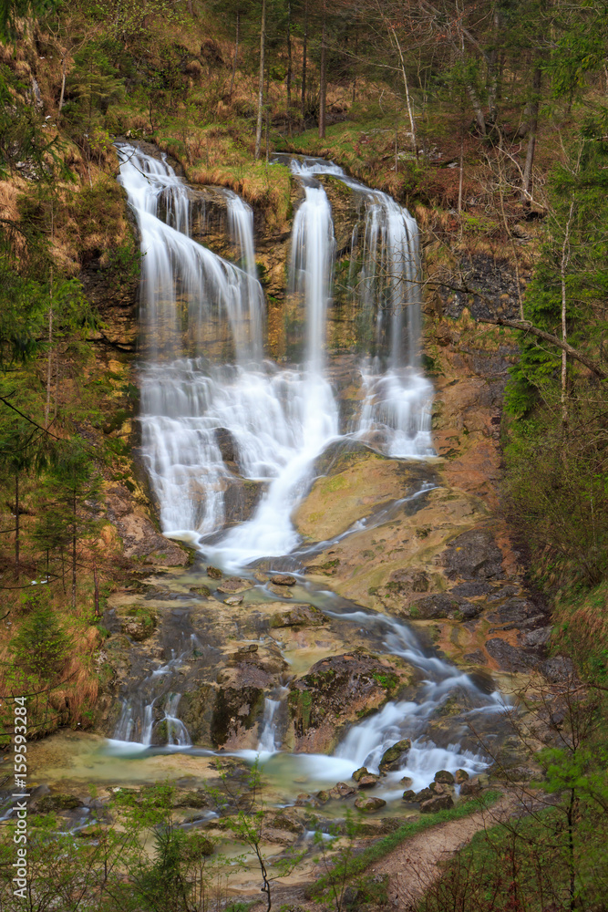 Obraz premium Waterfall at stream weissbach in bavaria, germany, vertical, long time exposure