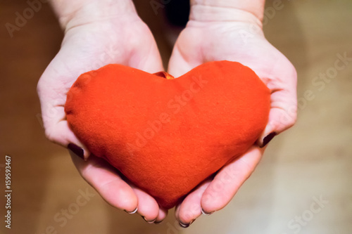 Young woman with red heart in hand