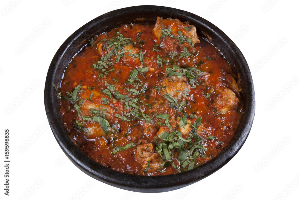 Chicken in Georgian in a spicy tomato sauce on a white background Chicken in Georgian in a spicy tomato sauce on a white background