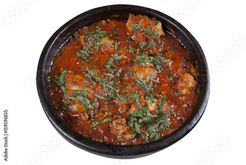 Chicken in Georgian in a spicy tomato sauce on a white background