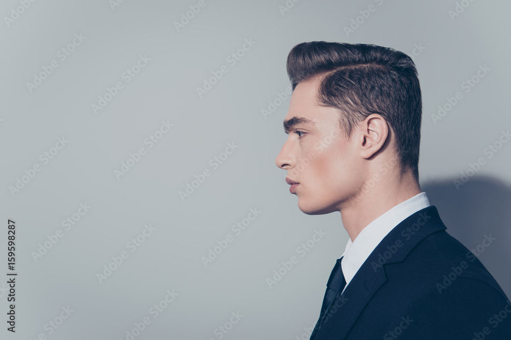 Side view of handsome mature guy with perfect hairstyle on pure light background. He is wearing suit Side view of handsome mature guy with perfect hairstyle on pure light background. He is wearing suit