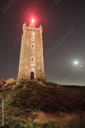 Scrabo Tower, built 1857, at night against a backdrop of stars along with the Moon and Venus