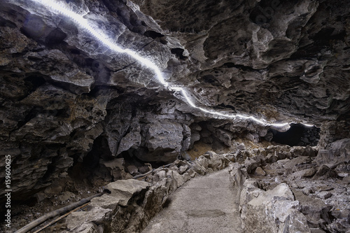 Entrance to ice cave. surrealist underground. The hole in cave, painted in fantastic colors photo