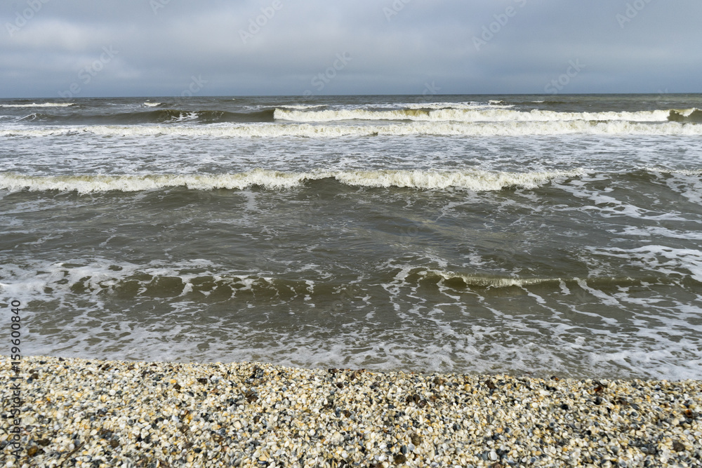 Landscape with sea view, waves and sea shells, clouds, photographed in Gura Portitei, Romania, in cloudy spring day Landscape with sea view, waves and sea shells, clouds, photographed in Gura Portitei, Romania, in cloudy spring day