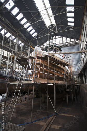 Scaffolding and boat in shipyard workshop