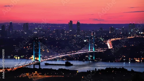 Istanbul Bosphorus Bridge on sunset. Illimunated bridge traffic at sunset in Istanbul, Turkey. HD, Timelapse Video.  photo